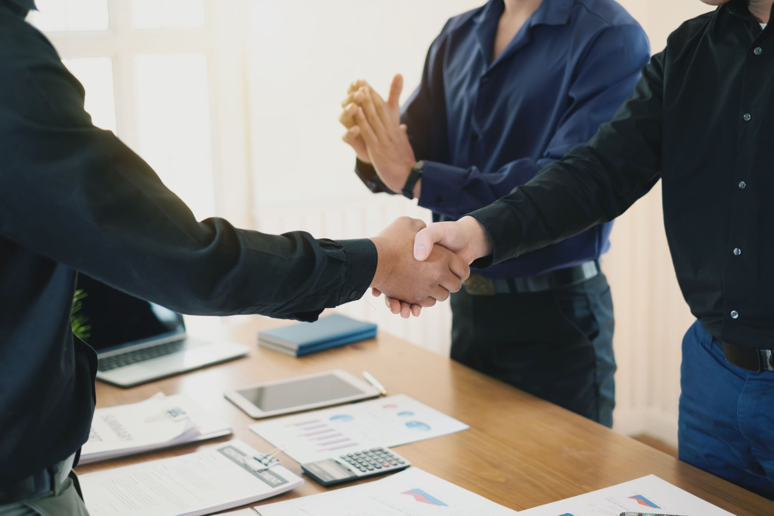 Businessman stand handshake and clapping of appreciation about the success of business at meeting. Businessman stand handshake and clapping of appreciation about the success of business at meeting.